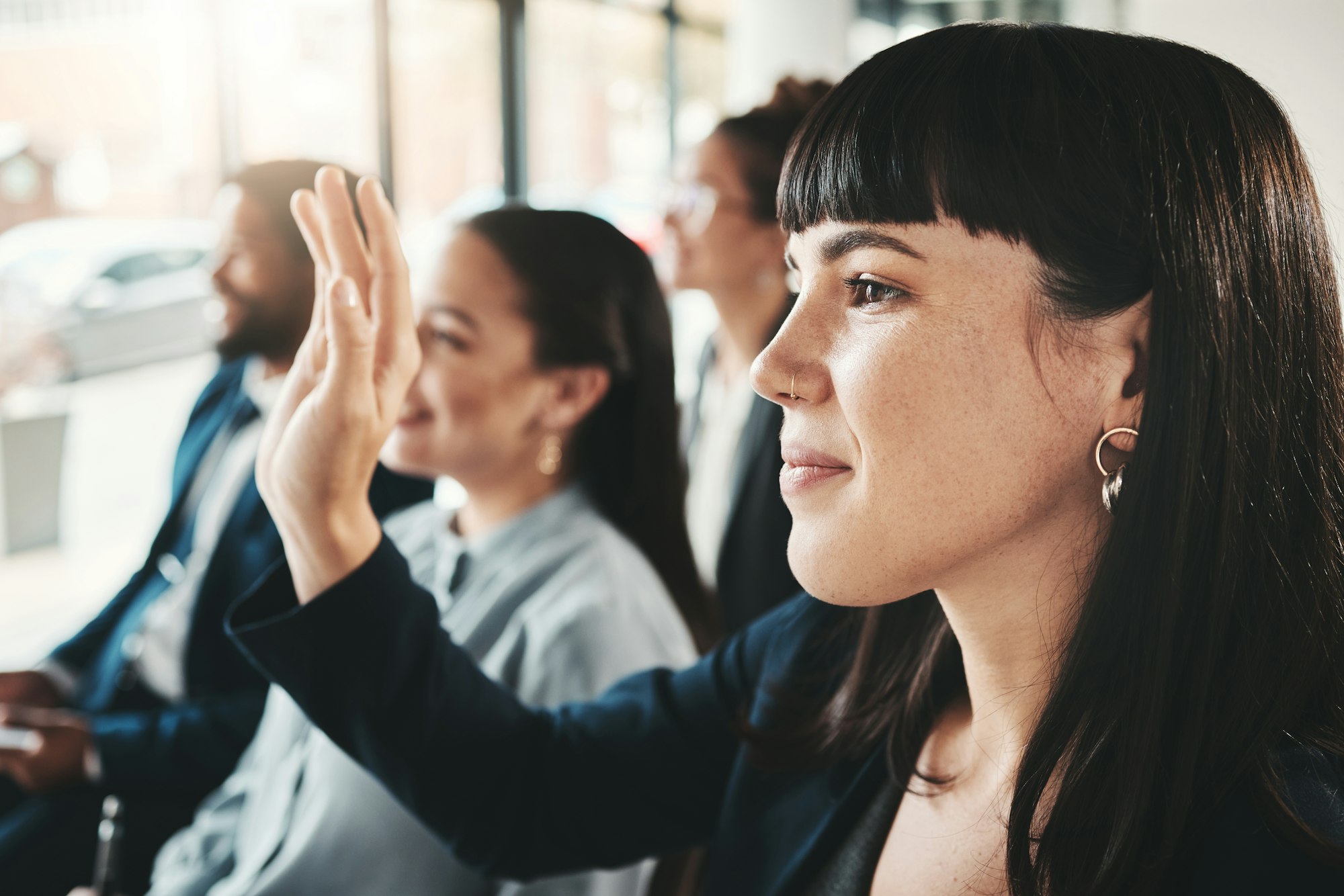 Business people, hand and audience in FAQ, presentation or answer at office workshop. Woman with ha